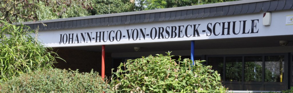 Startbild auf dem der Schriftzug "Johann-Hugo-von-Orsbeck-Schule" am Schuleingang zu sehen ist.